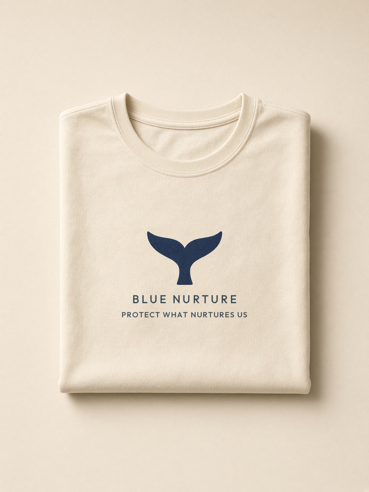 Folded cream tee with the navy fluke stack on the chest